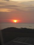 On the plane prior to take-off, sun is setting