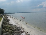 Beach at Punggol Point, single windsurfer coming back to shore