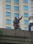 Another statue at the top of main entrance. Background is Raffles Hospital